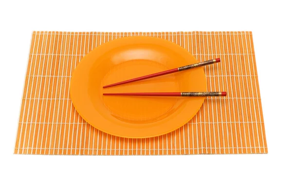 Yellow plate with chopsticks isolated — Stock Photo, Image