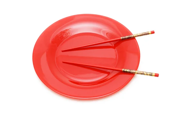 Red plate with chopsticks isolated — Stock Photo, Image