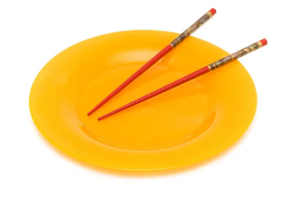 Жовта тарілка і палички — стокове фото