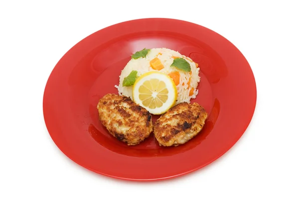 Schnitzels, rijst en citroen op de plaat — Stockfoto