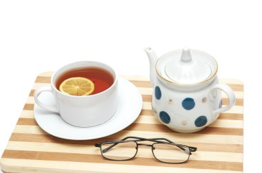 Cup of tea with lemon and pot isolated clipart