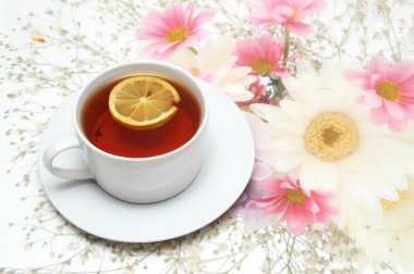 Cup of tea with lemon on flower clipart