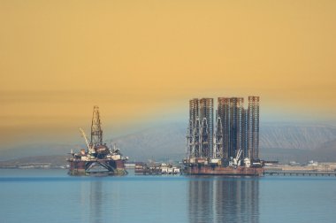 Two offshore rigs at Caspian shore clipart