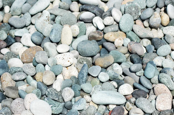 Montones de pequeños guijarros en la playa — Foto de Stock