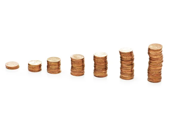 Pilhas de moedas isoladas no branco — Fotografia de Stock