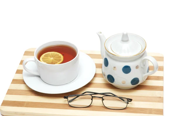 Cup of tea with lemon and pot isolated — Stock Photo, Image