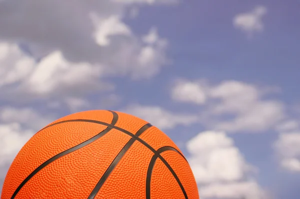 Orange basketball against the sky — Stock Photo, Image