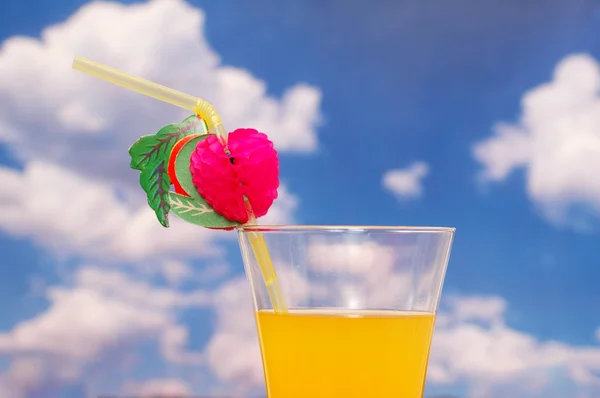 stock image Orange juice with straw against sky