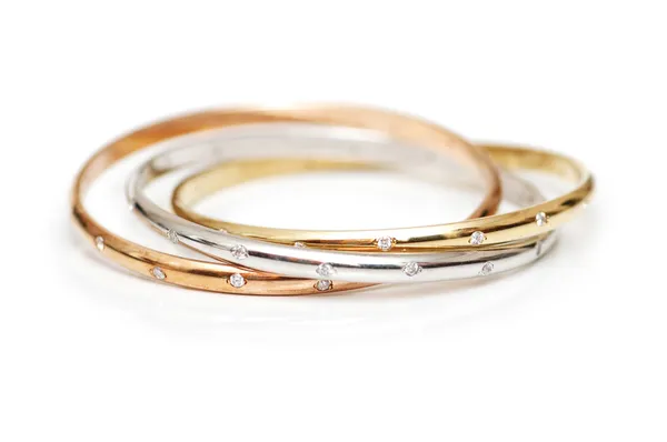 Three gold bracelets isolated — Stock Photo, Image
