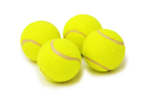 Четыре изолированных теннисных мяча — стоковое фото