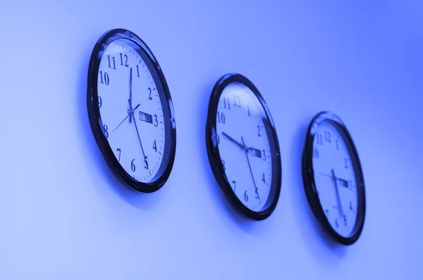Rad av runda klockor på väggen — Stockfoto
