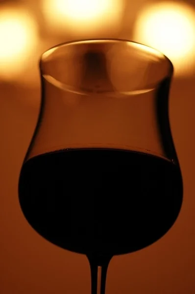 stock image Silhouette of wine glass against lights