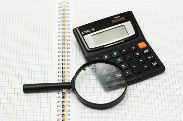 stock image Magnifying glass and calculator
