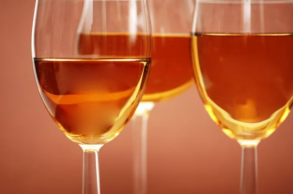 Three wine glasses on the biege — Stock Photo, Image