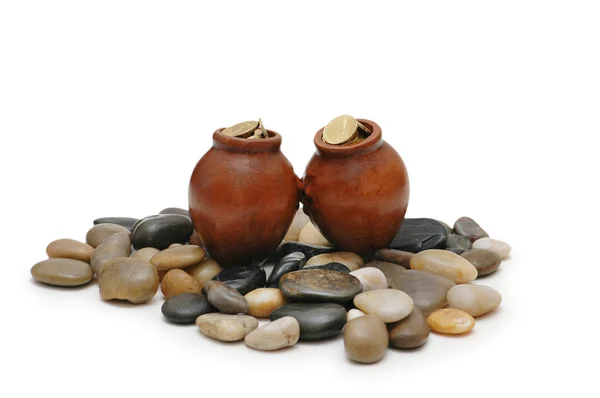 Two pots full of coin on pebbles — Stock Photo, Image