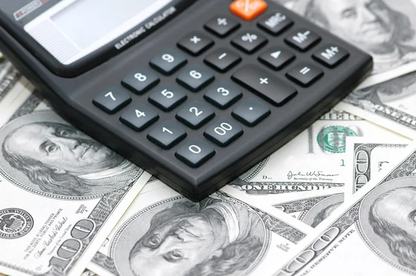 Accounting calculator over the dollars — Stock Photo, Image