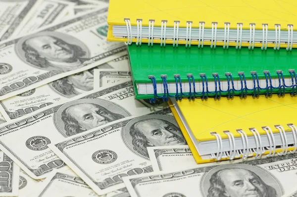 Three spiral notebooks and us dollars — Stock Photo, Image