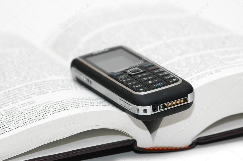 Mobile cellular phone over the book
