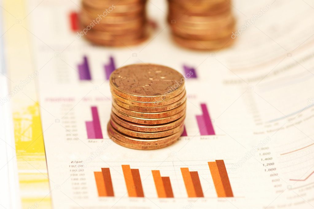 Stack of coins over bar charts