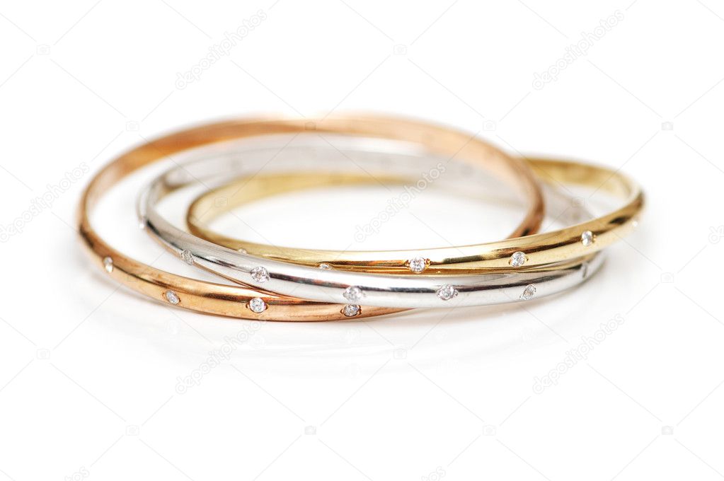 Three gold bracelets isolated