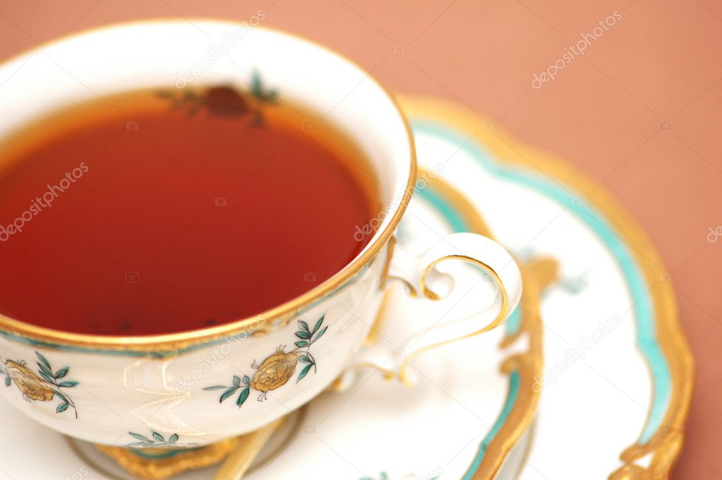 Cup of black tea on biege