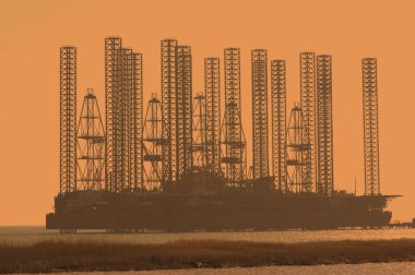 Offshore oil rig at shallow waters clipart