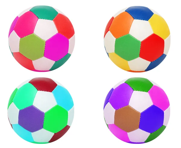 Футбольные мячи четырех разных цветов — стоковое фото