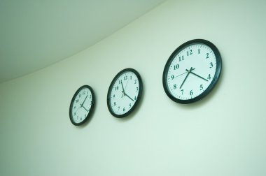 Row of clocks isolated on the wall clipart