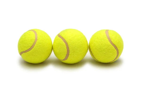 Три изолированных теннисных мяча — стоковое фото