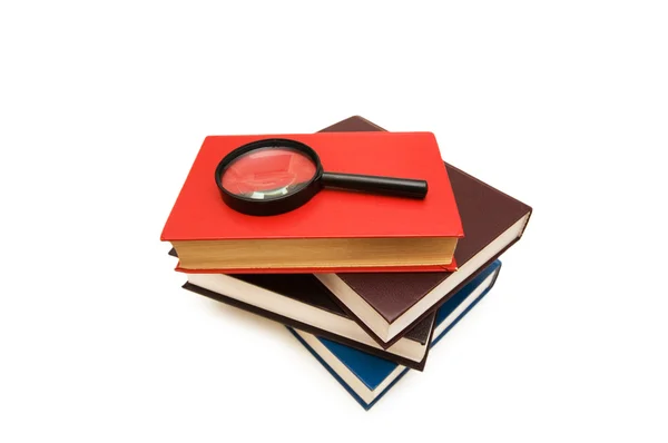 Magnifying glass over books — Stock Photo, Image