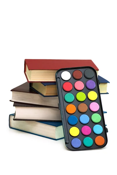Watercolour palette and stack of books — Stock Photo, Image