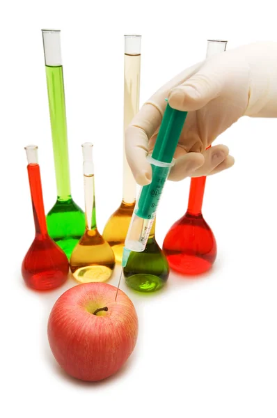 Hand injecting chemical into apple — Stock Photo, Image