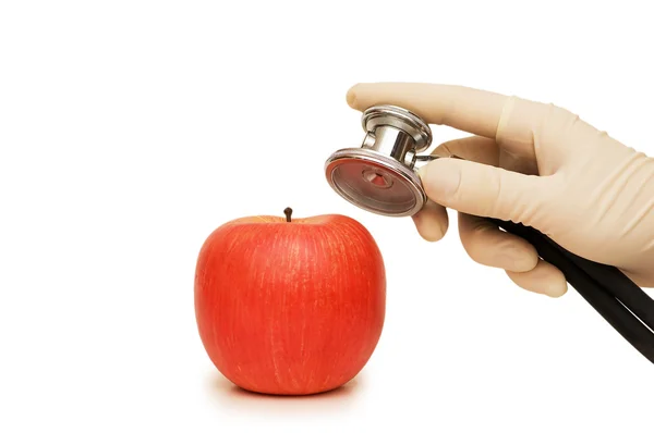 Stetoskop držení ruky a apple — Stock fotografie