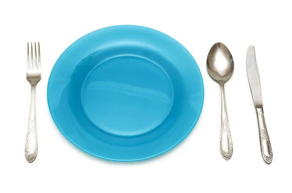 Stock image Blue plate and table utensils