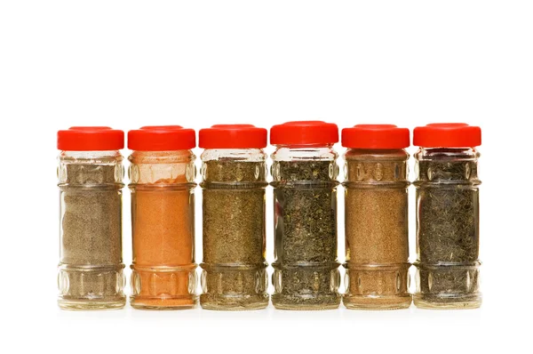 Various spices in bottles isolated — Stock Photo, Image