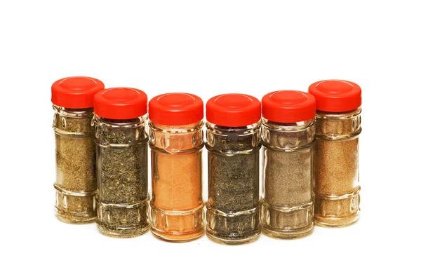 Various spices in bottles isolated — Stock Photo, Image