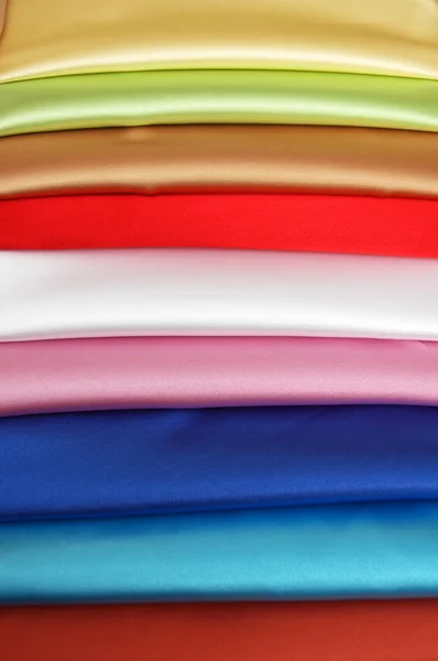Stack of satin fabric of various colours — Stock Photo, Image