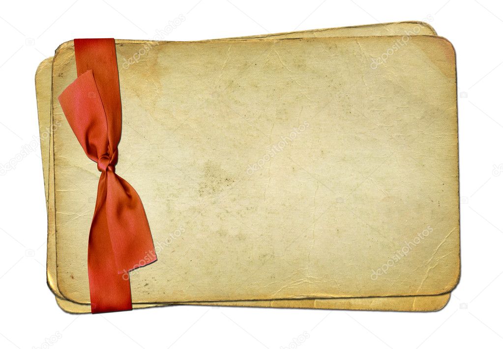 Grunge old papers with red bow on isolat