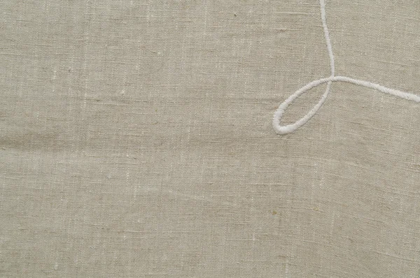 Белая вышивка на полотне — стоковое фото