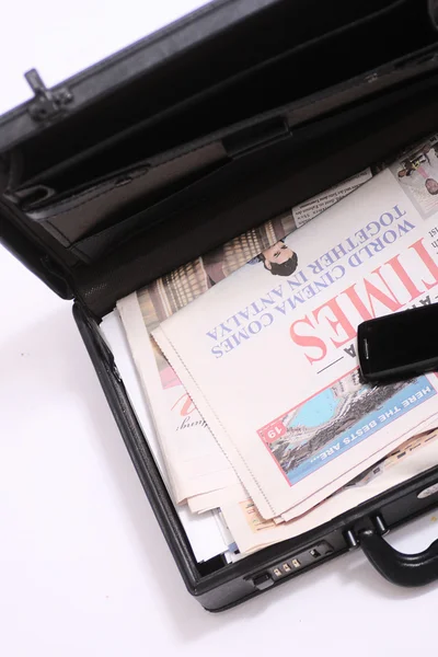 Briefcase with a newspaper — Stock Photo, Image