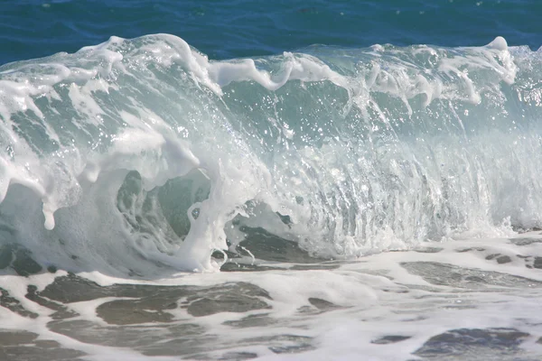 stock image Twirled sea wave approaching on coast