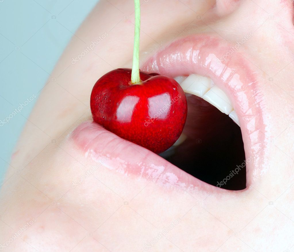 Young girl eating cherries