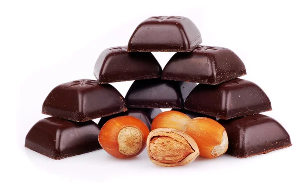 Bar of chocolate and hazelnuts on a whit — Stock Photo, Image