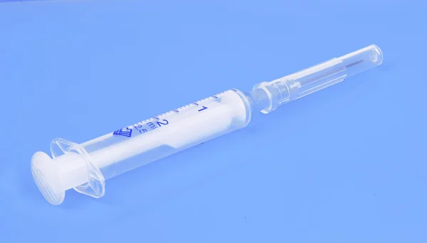 Syringe with needle in blue tones — Stock Photo, Image