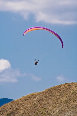 Paraglider in the blue sky clipart