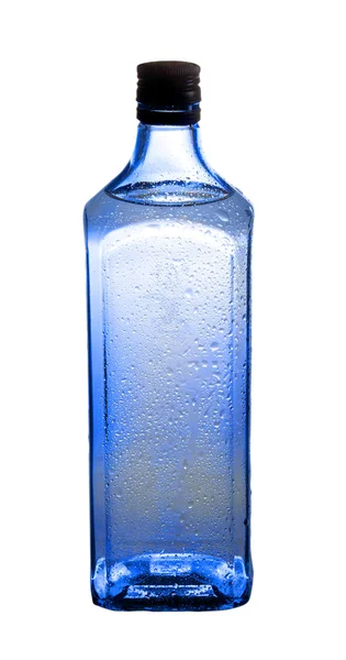 Синя пляшка з джином — стокове фото