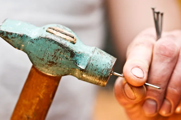 Hammer in a nail — Stock Photo, Image