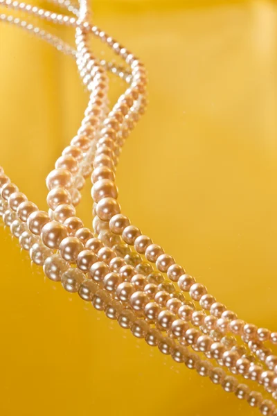 Beads on yellow — Stock Photo, Image