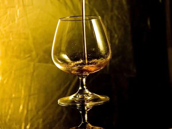 Pouring brandy — Stock Photo, Image