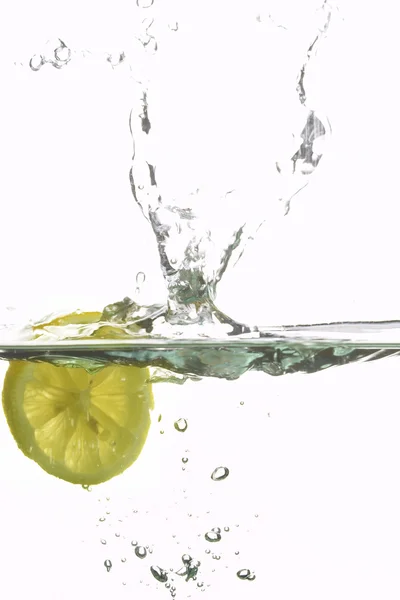 Lemon splashing water Royalty Free Stock Images